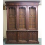 A VICTORIAN MAHOGANY GOTHIC REVIVAL BOOKCASE, with three pierced grill doors above three stylized