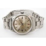 A TUDOR OYSTER WRISTWATCH with a stainless steel body and strap, the silvered dial has chevron and
