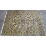 A CREAM GROUND PERSIAN HAND KNOTTED FINE KASHAN RUG with central medallion and matching spandrels