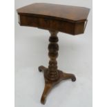 A VICTORIAN MAHOGANY SEWING TABLE the hinged lid enclosing various drawers and on a carved foliate