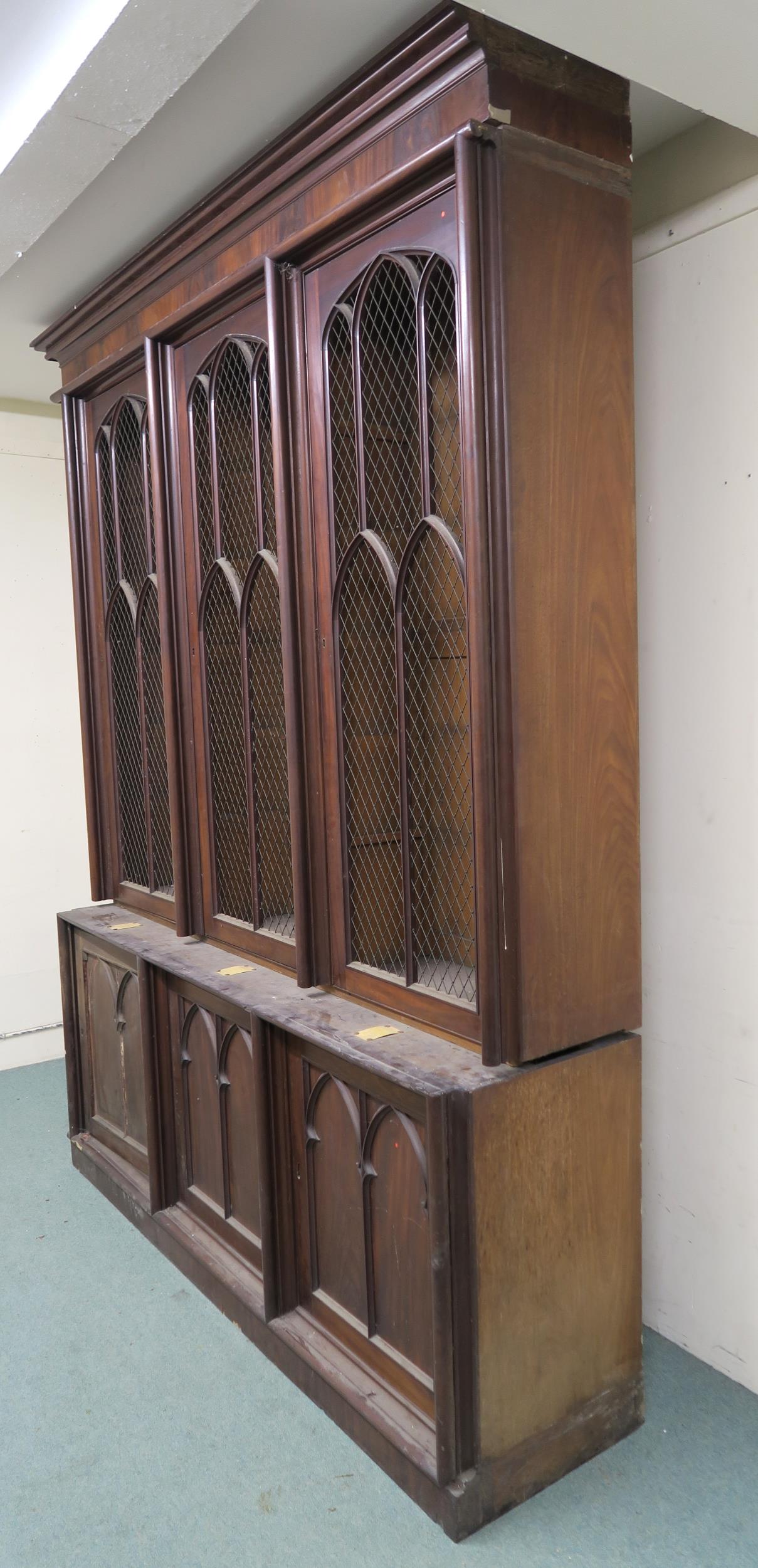 A VICTORIAN MAHOGANY GOTHIC REVIVAL BOOKCASE, with three pierced grill doors above three stylized - Image 4 of 10