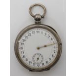 A SILVER CASED 24HR OPEN FACE POCKET WATCH white enamel dial with black Arabic numerals,