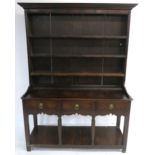 AN 18TH CENTURY OAK DRESSER the three tier plate rack above three drawers and a pot rail, 200cm