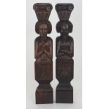A PAIR OF CARVED OAK FIGURAL PANELS depicting a male and female, the male with arms crossed, 51cm