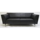 A CONTEMPORAY ROLF BENZ BLACK LEATHER UPHOLSTERED SOFA, on brushed steel supports, 73cm high x 195cm