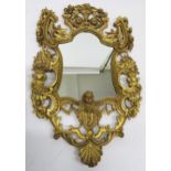 A GEORGIAN DESIGN GILTWOOD WALL MIRROR carved with angels heads, fruit, foliage and vases of flowers