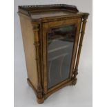 A VICTORIAN WALNUT VENEER MUSIC CABINET with fretted gallery above single glazed door, enclosing