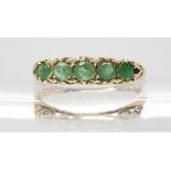 A 9ct gold five emerald ring with classic scrolled mount, size P, weight 2gms Condition Report: