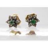 A pair of yellow and white metal emerald and diamond flower stud earrings, weight 2.4gms Condition