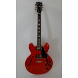 A Gibson Memphis ES-335 electric guitar, 2017 model serial number 11777712, in cherry red together