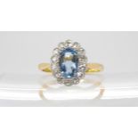 An 18ct gold aquamarine and diamond ring, set with an 8mm x 5.5mm x 3.6mm Aquamarine and estimated