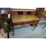 A 20th reproduction mahogany writing desk with green skiver on turned supports Condition Report: