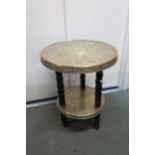 An early 20th century Oriental brass two tiered occasional table on turned supports Condition