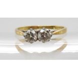 An 18ct gold twin stone diamond ring, set with two brilliant cut diamonds with a combined diamond
