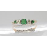 An 18ct gold and platinum emerald and diamond ring, the central square cut emerald is approx 3.5mm x