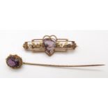 A yellow metal brooch set with a heart shaped amethyst, stamped 'GOLD' together with a yellow