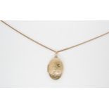 A 9ct gold oval locket with a 9ct herringbone chain, length 50cm, weight 8gms Condition Report: