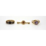 A 9ct gold amethyst ring by P&R Bushell 1978, size R1/2, a garnet ring size N, and a brooch,