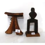 An Ethiopian wooden head rest and a West African figural pulley Condition Report:Not available for