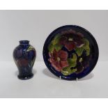 A Moorcroft Wisteria pattern vase and a Clematis pattern plate Condition Report:Available upon