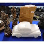 A pair of French spelter figures, a white glazed model of a car and a carved wooden bird