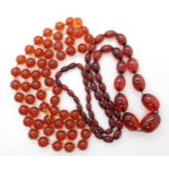 A string of cherry amber colour beads, weight approx 78.6gms, and a string of orange amber