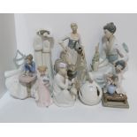 A collection of Lladro, Nao and other Spanish figures including a girl sat at a table with a