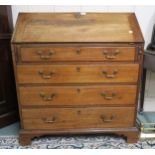 A C19th mahogany bureau, the writing surface inset with a green baize skiver, the whole raised on