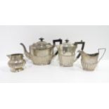 A matched three piece silver tea service, all of semi fluted form, the teapot by J Sherwood &