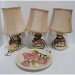 Three Moorcroft Magnolia pattern table lamps and a matching plate Condition Report:Available upon
