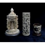 A Japanese carved ivory buddhist temple / shrine, a Chinese ivory spill vase with pierced dragon