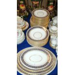 Royal Crown Derby dinner wares including plates, bowls and platters, with a blue and gilt leaf