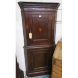 An oak corner cabinet with feather-banded top section and dentil cornice Condition Report: