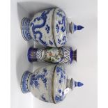 Two similarly shaped jars and covers, one decorated with a dragon, the other prunus branches,