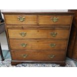 A Georgian mahogany two-over-three chest of drawers, on bracket feet, with pull-out writing