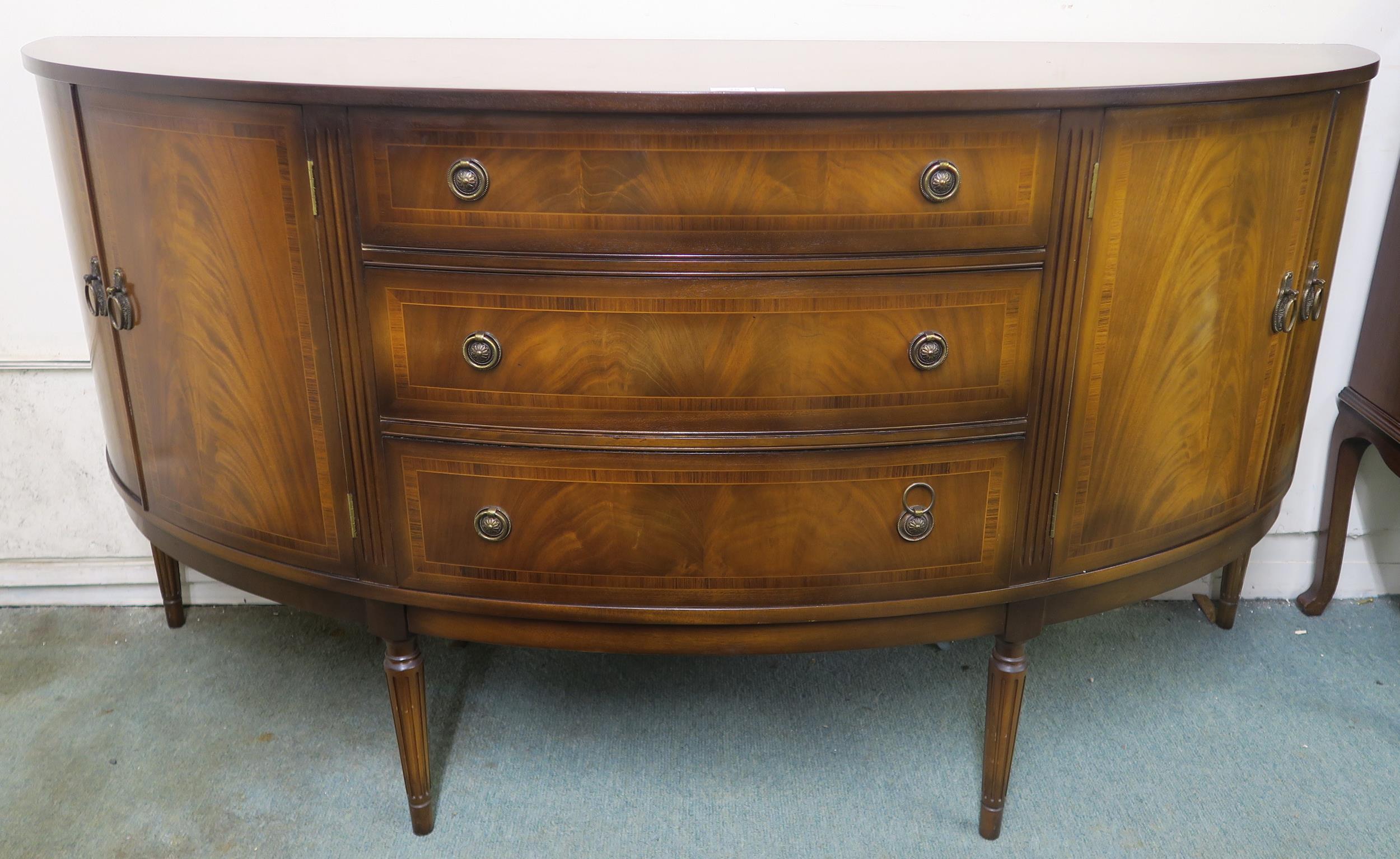 A 20th century mahogany dome fronted sideboard with three central drawers flanked by pairs of