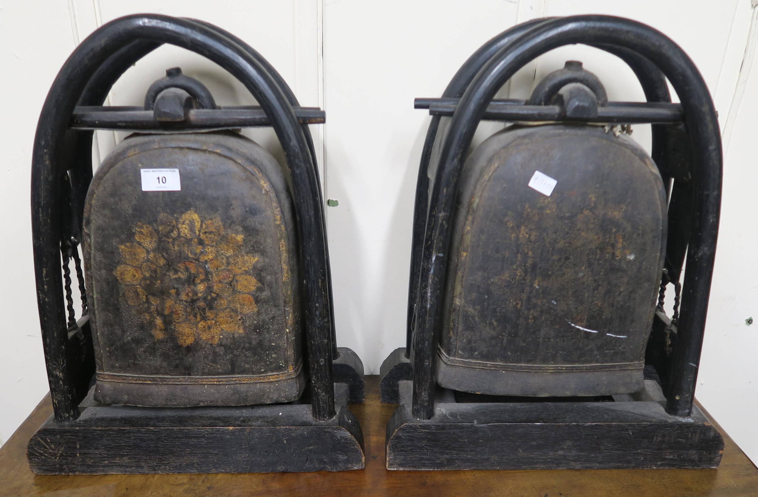 A pair of 19th century bronze Tibetan elephant temple bells on ebonised bentwood stands (2)