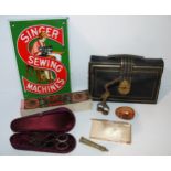 A tray lot including ribbon/umbilical scissors modelled as a stork, Singer modern enamel sign,