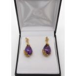 A pair of Rocks & Co, gold plated silver amethyst and pink gem set statement earrings. Condition