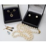 A 9ct gold sapphire pendant with matching earrings, a further pair of sapphire earrings, a 9ct white