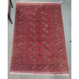 A red ground Bokhara rug with all over lozenge design, 198cm long x 131cm wide Condition Report: