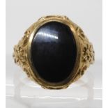 A 9ct gold onyx gents signet ring with decorative mount, size R1/2, weight 5.6gms Condition Report:
