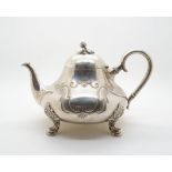 A danish silver teapot, of squat pear form with engraved rococo decoration with blank cartouches,