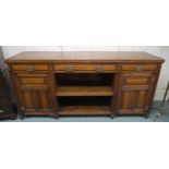 A Victorian oak sideboard with three drawers above open shelves flanked by panel doors, 100cm high x