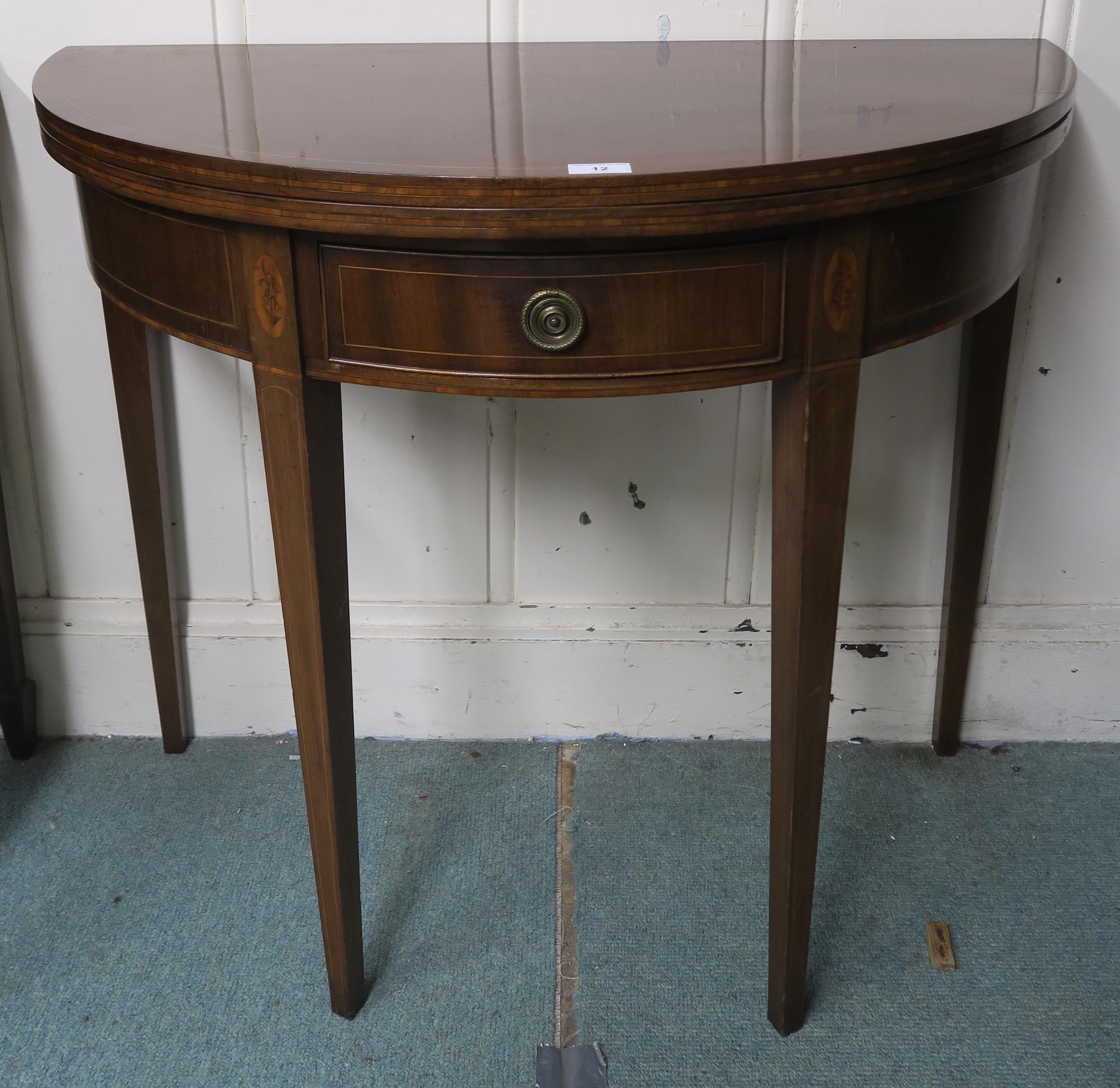 A Victorian mahogany demi lune single drawer fold over tea table on square tapering supports, 77cm