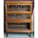 A 20th century mahogany Peter Graham Glasgow Hillhead three tier sectional bookcase with stained