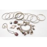A collection of silver and white metal bangles, charms, brooches etc Condition Report:Condition