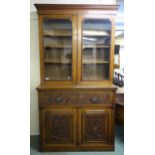 A Victorian oak secretaire bookcase with glazed two door bookcase above single drawer secretaire