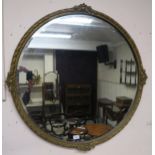 An early 20th century circular gilt gesso framed bevelled glass wall mirror, 87cm high x 87cm wide