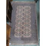 A beige ground Bokhara rug geometric lozenge design, 156cm long x 97cm wide Condition Report: